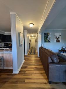 a living room with a couch and a hallway at Beech Mountain Getaway in Beech Mountain