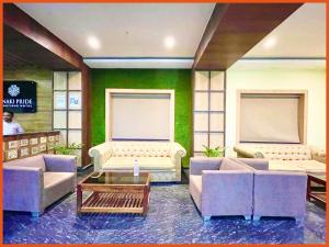a living room with two couches and a table at HOTEL PRIME J & K INN - NEAR SEA BEACH - Restaurant - #Lift And Parking Facilities - #fully Air Conditioned hotel at Prime Location - #BREAKFAST included -LUXURAY HOTEL IN PURI in Puri