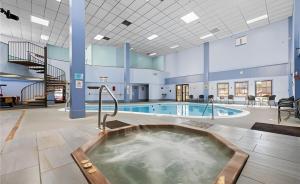 a large pool with a hot tub in a building at Beech Mountain Getaway in Beech Mountain