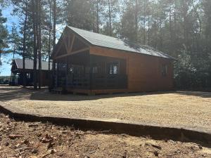 a large wooden cabin in the middle of a forest at EL PINO - domek w lesie in Skrzynka