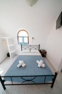 a bedroom with a bed with two pillows on it at Villa Dima - Boutique Hotel in Perissa +7 photos