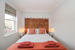 a bedroom with a large bed with two towels on it at Pilgrims Rest in Worle