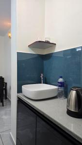 a white sink sitting on top of a counter at Elora Homes in Vagamon +16 photos