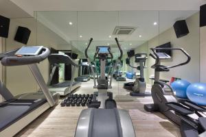 a gym with treadmills and cardio machines in a room at The Atara in Gurgaon