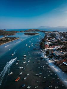 an aerial view of a beach with boats in the water at Flat in 4-star hotel with panoramic pool in Cabo Frio