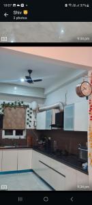 a kitchen with white cabinets and a sink at Sweethome in Lāndrān