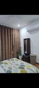 a bedroom with a bed with a comforter on it at Sweethome in Lāndrān