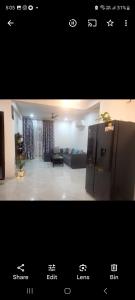 a view of a living room with a couch and a refrigerator at Sweethome in Lāndrān