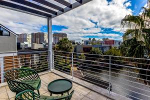 a balcony with chairs and a table and a view at Quayside 301 by CTHA in Cape Town