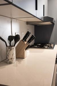 Una cocina con una encimera con un bloque de cuchillos. en The Burg Collection - Suit One, en Ciudad del Cabo