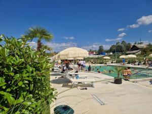 a pool with a bunch of people at a resort at Hotel Maya in Horezu