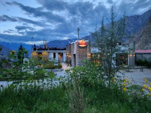 a building with a sign on the side of it at Hunza Hard Rock Resort in Baltit