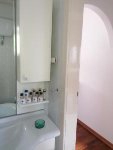 a bathroom with a white sink and a mirror at Apartment Trieste Casa Vacanze NATASCIA in Trieste