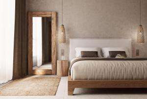 a bedroom with a large bed and a mirror at Elion Villas in Kos Town