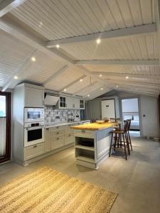 a large kitchen with white cabinets and a counter at Garden Bungalow in Antalya