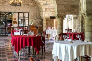a restaurant with two tables with red and white table cloth at Hattonchatel Château & Restaurant La Table du Château in Hattonchâtel