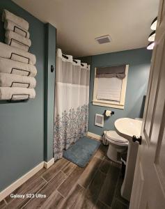 a bathroom with a toilet and a sink at Reel Relaxin Retreat to Getaway! in Houghton Lake