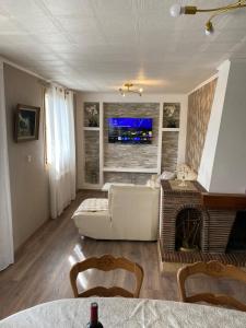 a living room with a couch and a fireplace at Maison individuelle, 3chambres, avec parking in Le Grand-Quevilly