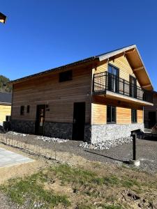a building with a balcony on the side of it at Chalet am See! in Afritz