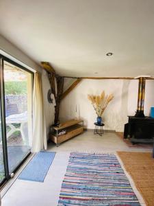 a living room with a large window and a fireplace at La Grange in Thollet