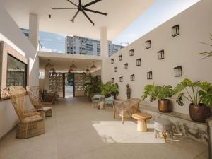 a lobby of a building with chairs and plants at Bali Hotel Adults Only Isla Verde, a Trademark by Wyndham in Carolina