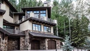 a large house with a balcony on top of it at Alpenzauber Lodge in Vail