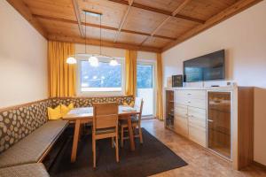 a dining room with a table and a couch at Haus Larcher in Neustift im Stubaital