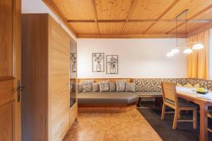 a living room with a couch and a table at Haus Larcher in Neustift im Stubaital +28 photos
