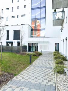 a building with a brick walkway in front of it at Incredible Luxury Apt with Garage and Tram Station in Prague