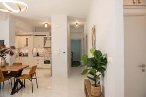 a kitchen and dining room with a table and chairs at AGRELLI Hotel & Suites in Kardamaina