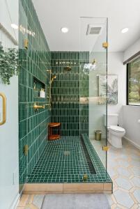 a bathroom with a shower with green tile at Mid-Mod Hilltop Retreat Views & Local Wildlife in Atascadero +56 photos