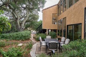 a patio with a table and chairs in front of a building at Mid-Mod Hilltop Retreat Views & Local Wildlife in Atascadero