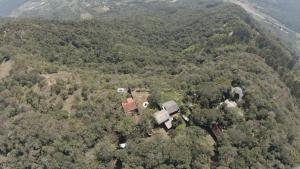 an aerial view of a house in the middle of a forest at Pousada das Nuvens in Nova Petrópolis +2 photos