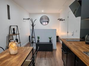 a kitchen with a table and a dining room at L'Escapade Urbaine in Villeneuve-sur-Lot +33 photos