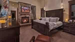 a bedroom with a bed and a fireplace at Appaloosa Mountain Lodge in Steamboat Springs