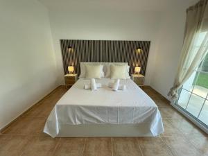 a bedroom with a large white bed with two lamps at Charming villa in Nerja in Nerja +34 photos