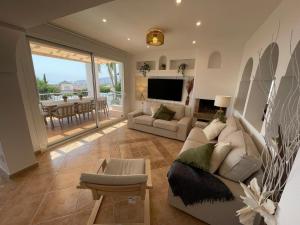 a living room with a couch and a television and a table at Charming villa in Nerja in Nerja