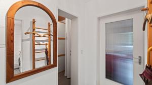 a mirror in a hallway next to a door at Seenest 'Paradies' mit Parkplatz in Konstanz