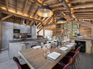 a dining room with a large wooden table and chairs at Chalet savoyard 5 chambres avec sauna, navette gratuite et prestations haut de gamme, proche pistes - FR-1-570-8 in Saint-Martin-de-Belleville +8 photos