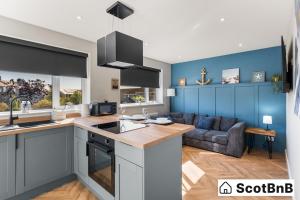 a kitchen and living room with a couch at Contractor Housing - Parking - Long Stay Discounts in Aberdeen
