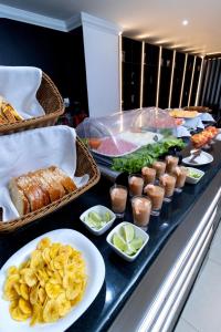 a buffet line with food on a table at Hotel Plaza Monte Carlo in Guayaquil