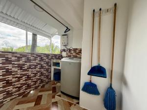 a kitchen with blue mop cleaners on the wall at GURUS FR Luminoso Amplio Cómodo en excelente ubicación in Pereira