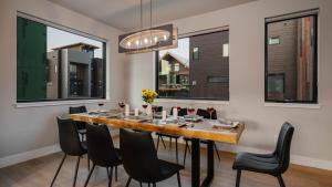 a dining room with a large wooden table and black chairs at Borough House in Steamboat Springs