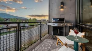 a balcony with a stove and a table with a glass of wine at Borough House in Steamboat Springs +21 photos