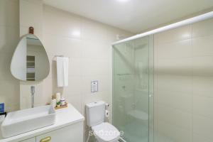 a bathroom with a shower and a toilet and a sink at Apto c/ 1 Suíte a 90 m da Praia SEM0012 in Barra Velha +4 photos