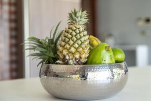 a bowl of pineapple and other fruit on a table at Villa Azur in Saint-François