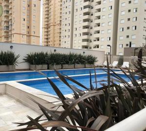 a swimming pool with plants on a building at Apartment in Osasco in Osasco