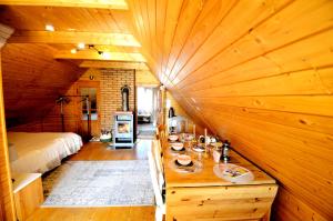a room with a bed and a wooden wall at Öökulli öömaja in Tartu +4 photos