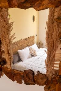 a bedroom with a bed made out of a tree stump at The Flow Host in Tamraght Ouzdar