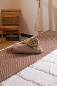 a bed with a rolled up towel on top of it at The Flow Host in Tamraght Ouzdar +36 photos